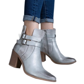 Silver high-heeled ankle boots decorated with a cutout