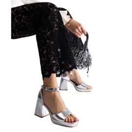 Silver women's sandals with a massive metallic heel