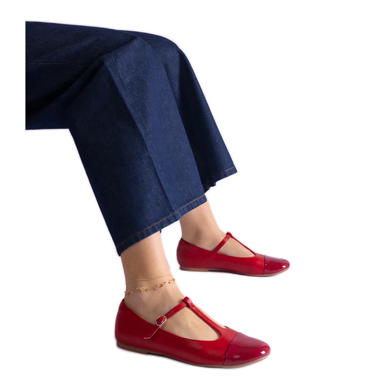 Red ballet flats with a patent toe and fastened with a buckle