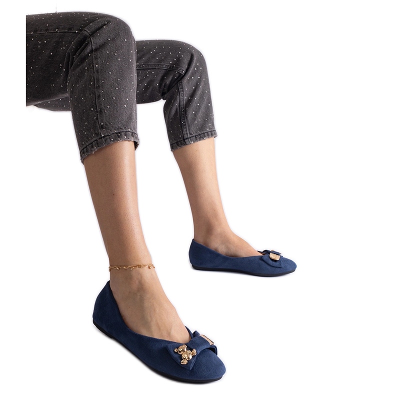 Navy blue ballet flats decorated with a bow and brooch