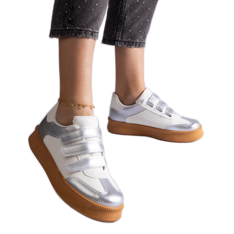 Silver sneakers fastened with Velcro