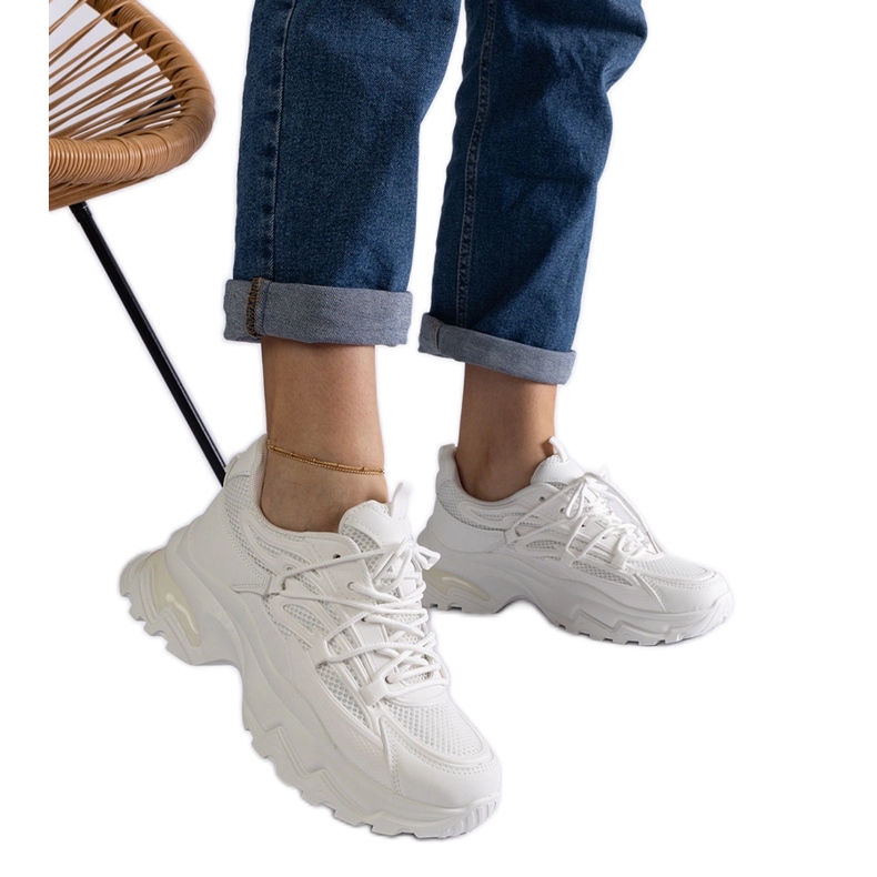White sports sneakers with a massive sole White sports sneakers with a massive sole