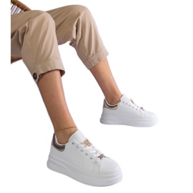 White sneakers on the platform decorated with a butterfly White sneakers on the platform decorated with a butterfly