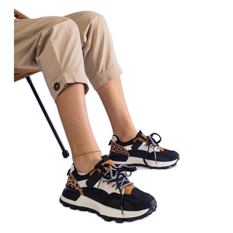 Black sneakers decorated with an animal motif Black sneakers decorated with an animal motif