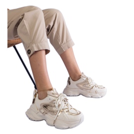 Beige women's sports sneakers on a massive sole Beige women's sports sneakers on a massive sole