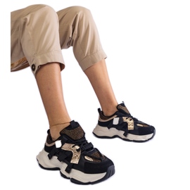 Black sneakers with gold inserts