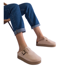 Beige women's flip flops on the platform with a buckle
