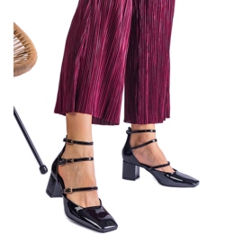 Black pumps varnished on a post with buckles