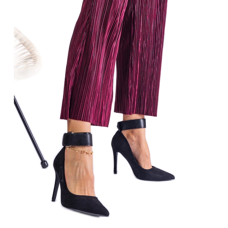 Black pumps with a high heel made of suede eco-leather