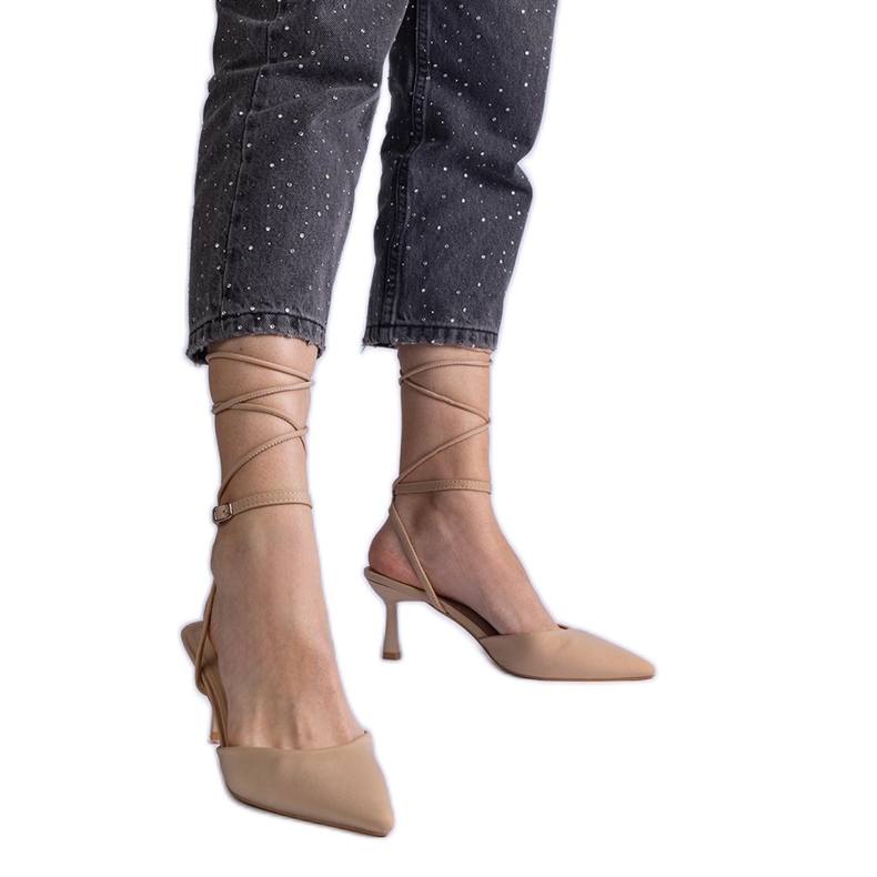 Beige high heels with an open heel, tied around the ankle