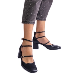 Black pumps on the pillar with buckles