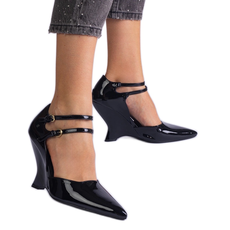 Black pumps varnished on wedges with buckles