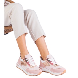 Pink sneakers on the platform decorated with glitter
