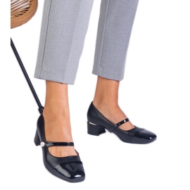Black pumps on the post with a varnished toe