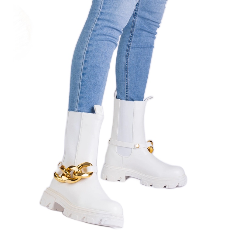 White ankle boots decorated with a massive chain