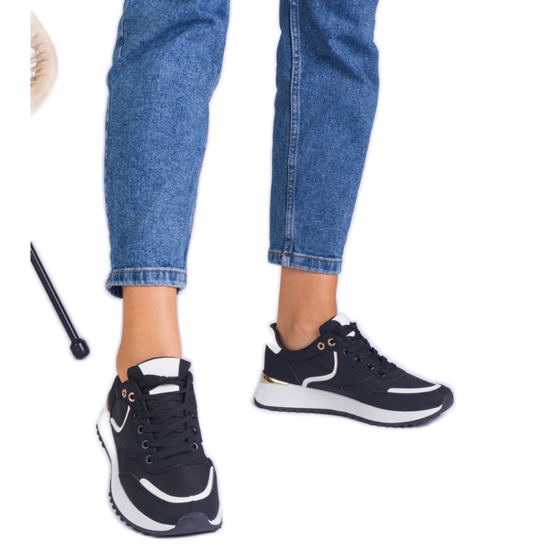 Black women's sneakers with a golden insertion Black women's sneakers with a golden insertion