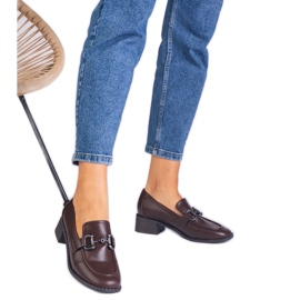 Brown pumps on a post with a metallic decoration