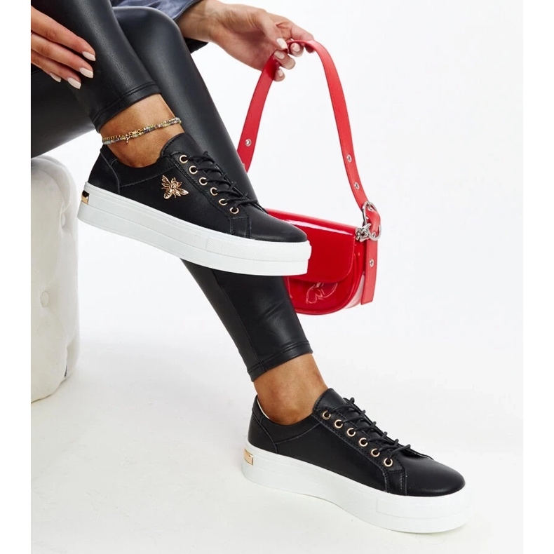 Black leather sneakers on the thick sole of Mikka