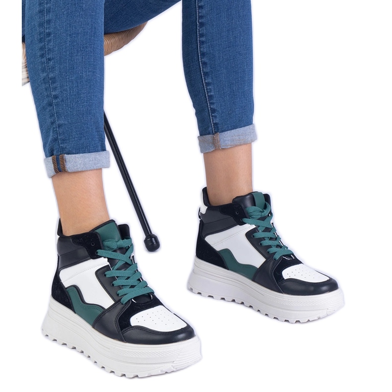 Black and white women's sports sneakers on the platform