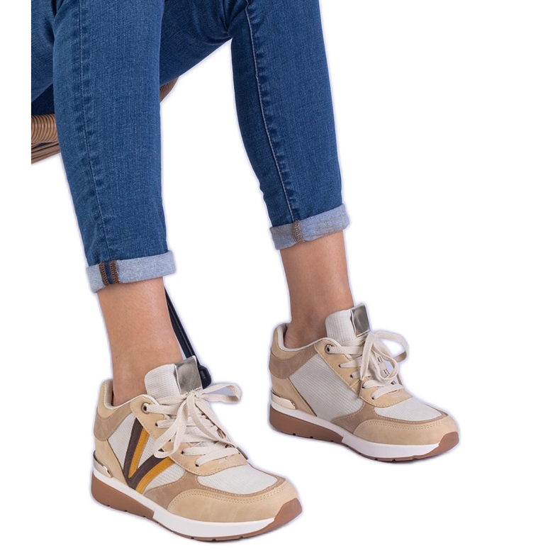 Brown women's sneakers on a hidden wedge