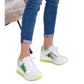 White women's sports sneakers with a colorful accessory