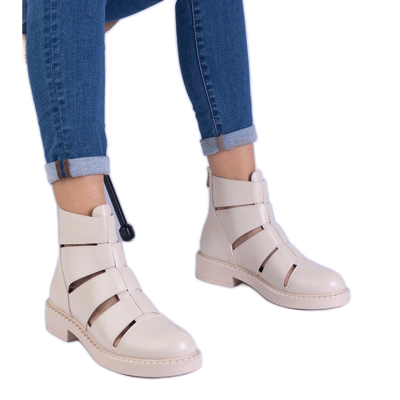 Beige boots made of eco -leather with flat -heeled cutouts Beige boots made of eco -leather with flat -heeled cutouts