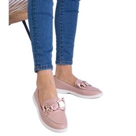 Pink loafers decorated with a bow and a golden teddy bear Pink loafers decorated with a bow and a golden teddy bear
