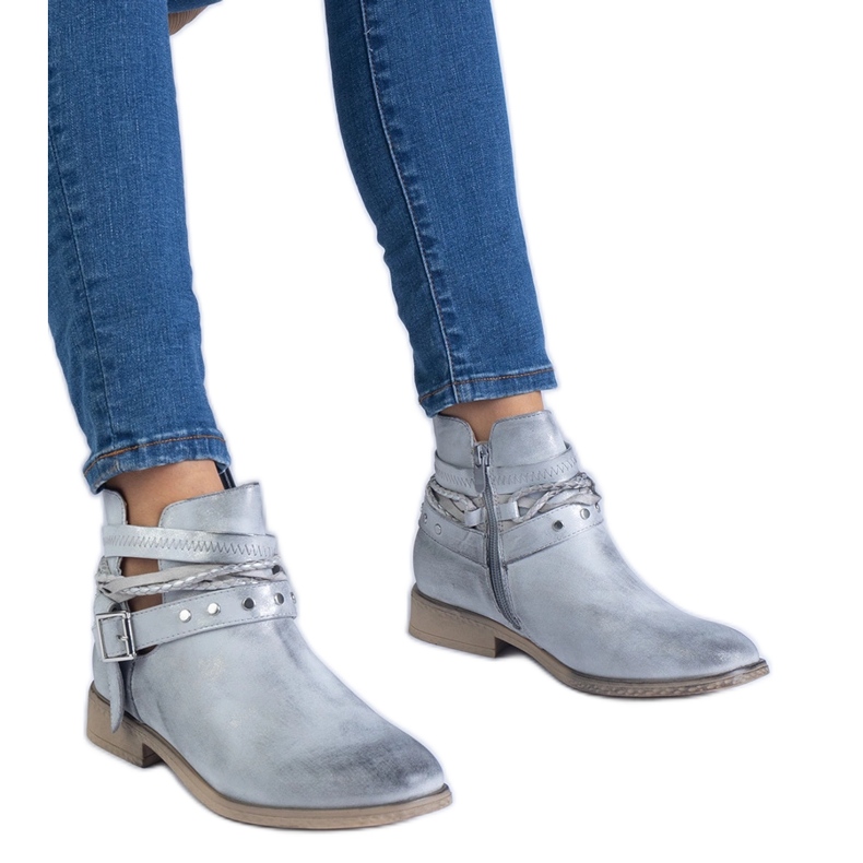 Silver flat boots with a cutout and a buckle