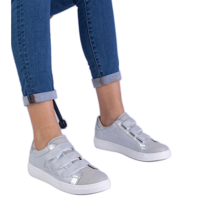Silver women's sneakers fastened with Velcro