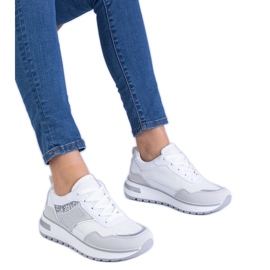 White sneakers decorated with glitter and zircons