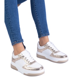 Golden sneakers on a thick sole