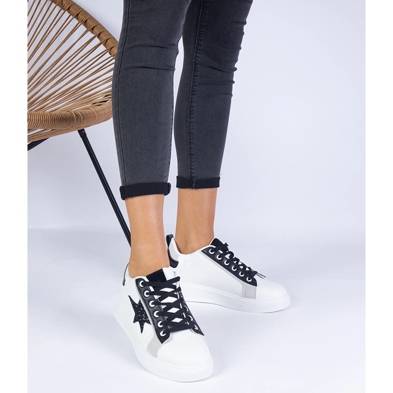 White sneakers decorated with a glitter star