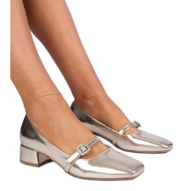 Golden elegant pumps decorated with zircons