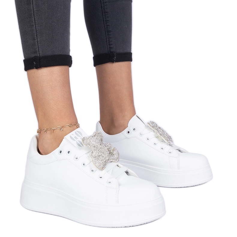 White women's sneakers decorated with a teddy bear in rhinestones