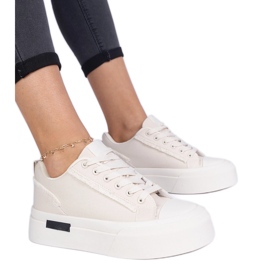Beige women's material sneakers on the platform Beige women's material sneakers on the platform