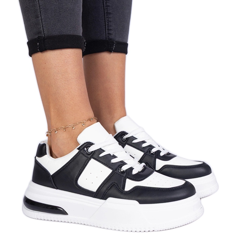 Black and white women's sneakers with a thick sole