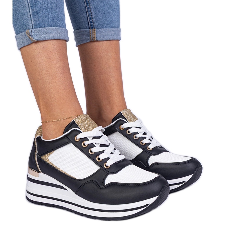 Black sneakers decorated with glitter and a metal insert Black sneakers decorated with glitter and a metal insert