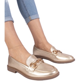 Golden women's loafers with golden decoration