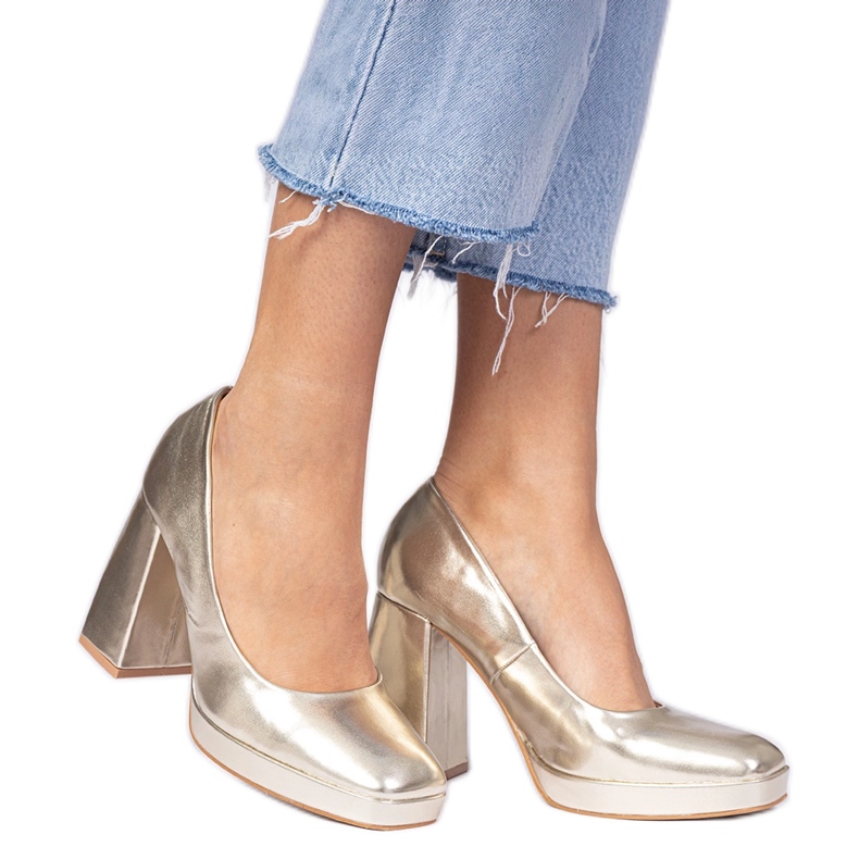 Golden metallic pumps on a massive post with a square toe