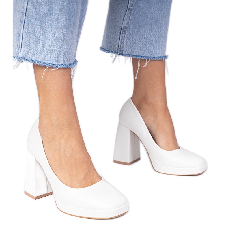 White pumps on a massive post with a square toe