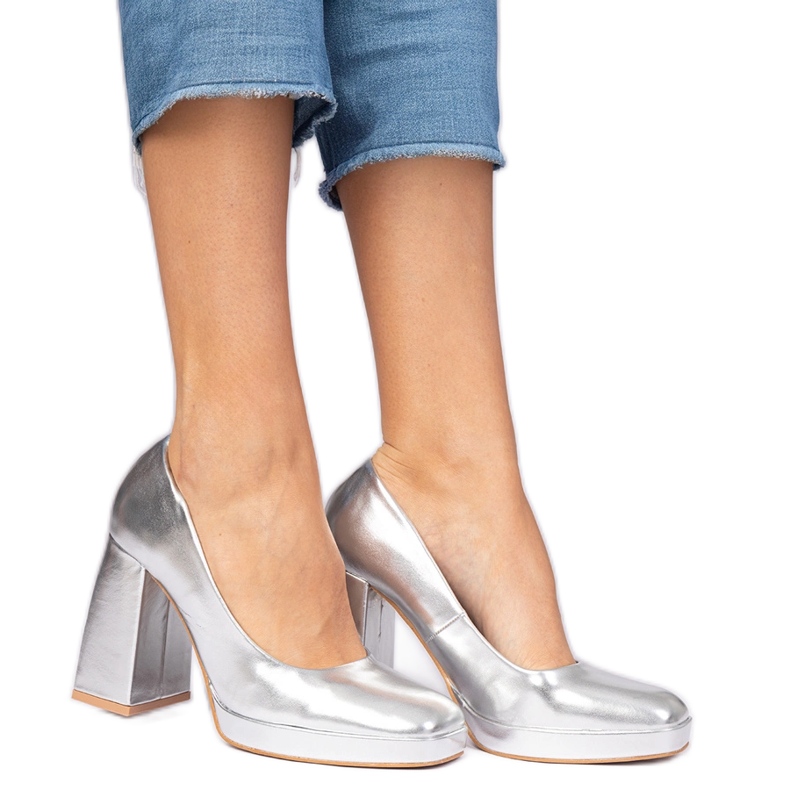 Silver metallic pumps on a massive post with a square nose and