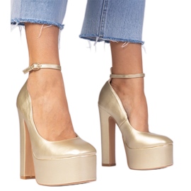 Gold metallic pumps on a high post golden