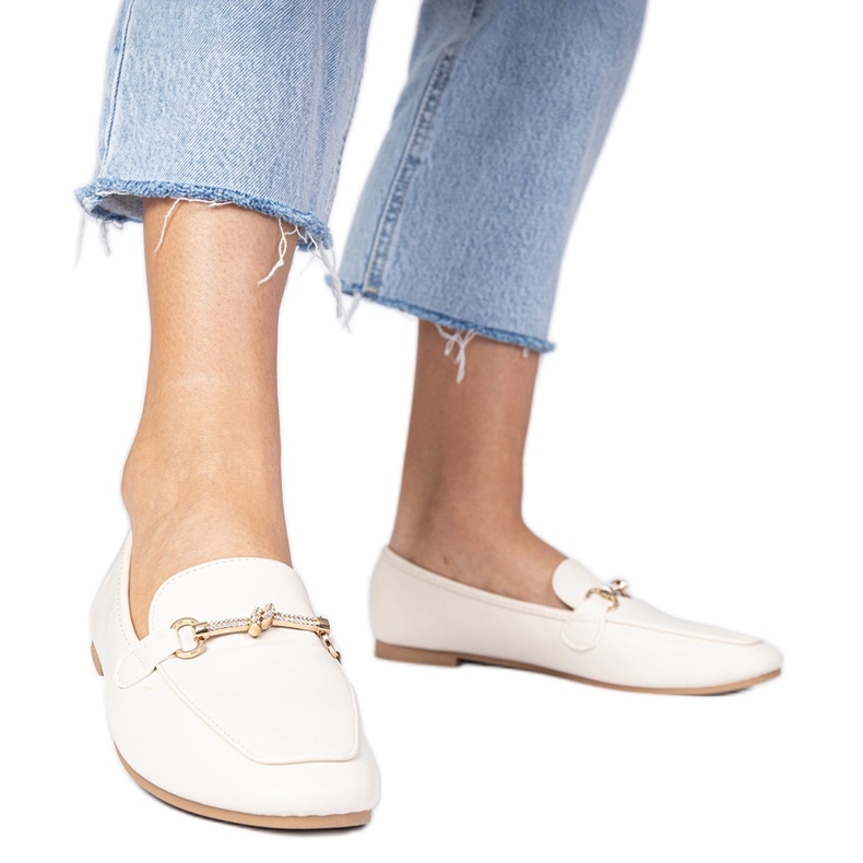 Beige elegant loafers with a golden decoration and zircons