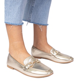 Golden elegant loafers with zircons