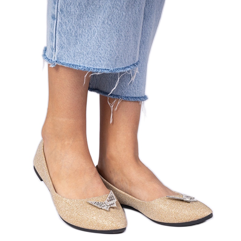 Golden women's glitter ballerinas with a butterfly