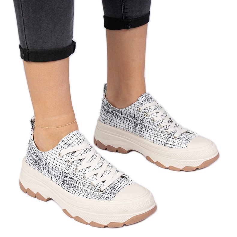 Black and white sneakers on a thick sole