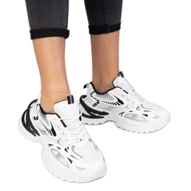 White sports sneakers with a massive sole