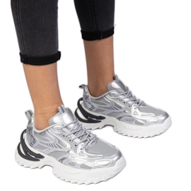 Silver sports sneakers on a massive sole