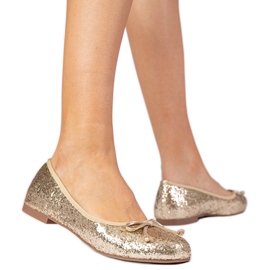 Golden women's glitter ballerinas with a bow