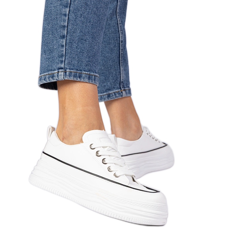 White women's sneakers on a high sole